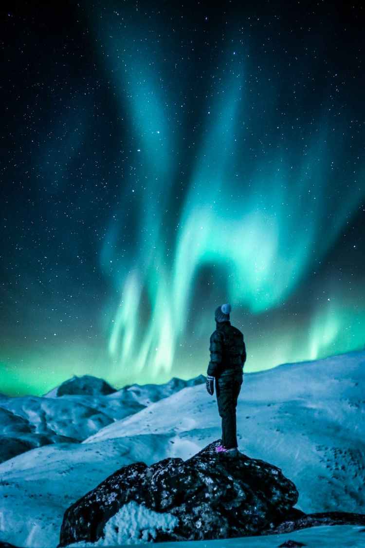 man standing near snow field